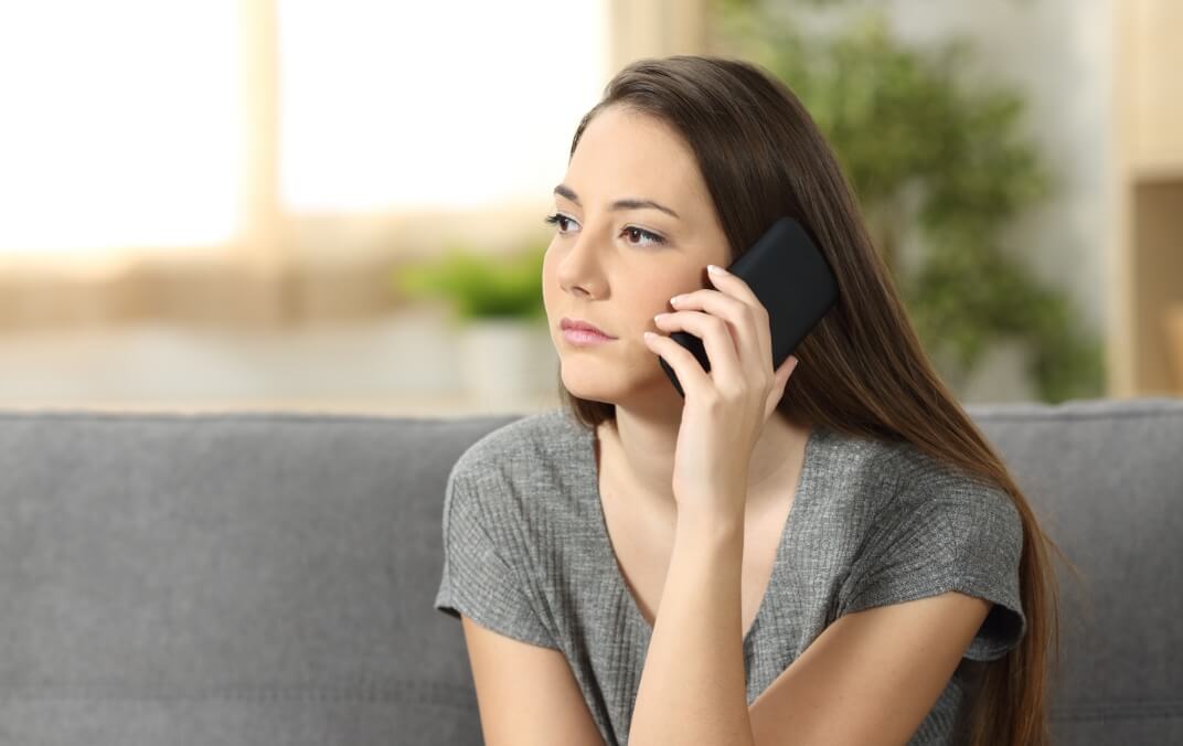Young woman on cell phone looking for mental health support